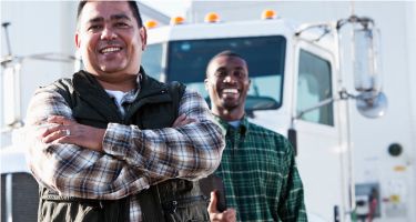 two men in front of truck